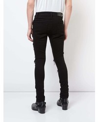 schwarze enge Jeans mit Destroyed-Effekten von Amiri