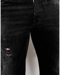 schwarze enge Jeans mit Destroyed-Effekten von Asos