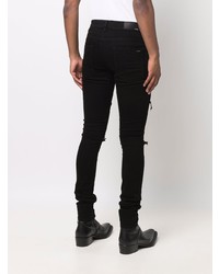 schwarze enge Jeans mit Destroyed-Effekten von Amiri