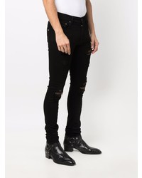 schwarze enge Jeans mit Destroyed-Effekten von Amiri