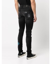 schwarze enge Jeans mit Destroyed-Effekten von Amiri