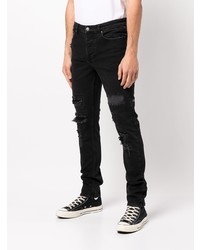 schwarze enge Jeans mit Destroyed-Effekten von Ksubi