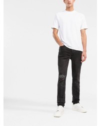 schwarze enge Jeans mit Destroyed-Effekten von Ksubi