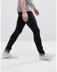 schwarze enge Jeans mit Destroyed-Effekten