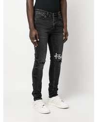 schwarze enge Jeans mit Destroyed-Effekten von Ksubi