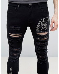 schwarze enge Jeans mit Destroyed-Effekten