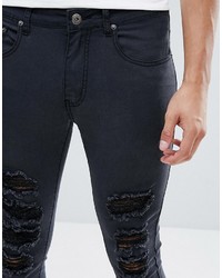 schwarze enge Jeans mit Destroyed-Effekten