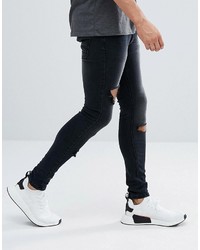 schwarze enge Jeans mit Destroyed-Effekten