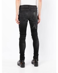 schwarze enge Jeans mit Destroyed-Effekten von Amiri