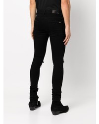 schwarze enge Jeans mit Destroyed-Effekten von Amiri
