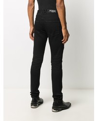 schwarze enge Jeans mit Destroyed-Effekten von Balmain