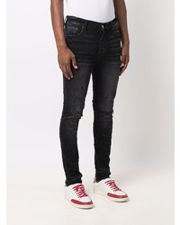 schwarze enge Jeans mit Destroyed-Effekten von Amiri