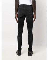 schwarze enge Jeans mit Destroyed-Effekten von Amiri