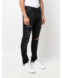 schwarze enge Jeans mit Destroyed-Effekten von Amiri