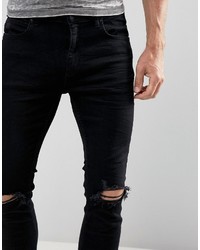 schwarze enge Jeans mit Destroyed-Effekten