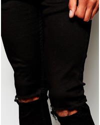 schwarze enge Jeans mit Destroyed-Effekten von Reclaimed Vintage