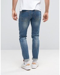 schwarze enge Jeans mit Destroyed-Effekten von Asos