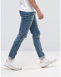 schwarze enge Jeans mit Destroyed-Effekten von Asos