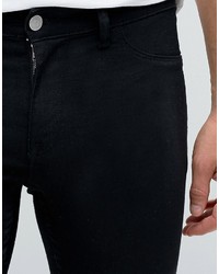 schwarze enge Jeans mit Destroyed-Effekten von Asos