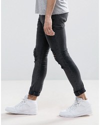 schwarze enge Jeans mit Destroyed-Effekten von Asos