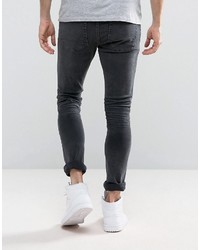 schwarze enge Jeans mit Destroyed-Effekten von Asos