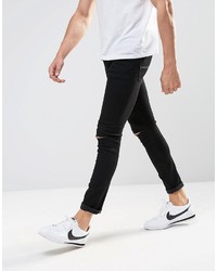 schwarze enge Jeans mit Destroyed-Effekten von Asos