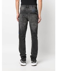 schwarze Jeans mit Destroyed-Effekten von Ksubi