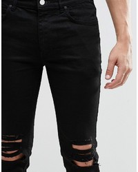 schwarze Jeans mit Destroyed-Effekten von Religion