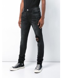 schwarze Jeans mit Destroyed-Effekten von Amiri