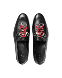 schwarze Leder Slipper mit Schlangenmuster von Gucci