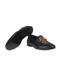 schwarze Leder Slipper mit Schlangenmuster von Gucci