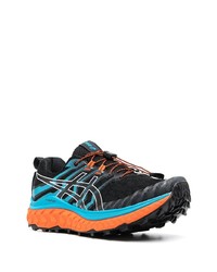 schwarze und blaue Sportschuhe von Asics