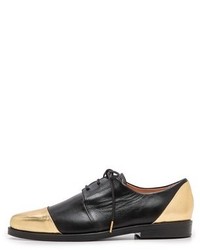 schwarze und goldene Leder Oxford Schuhe von Thakoon