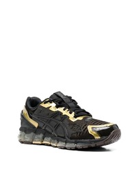 schwarze und goldene Sportschuhe von Asics