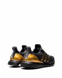 schwarze und goldene Sportschuhe von adidas