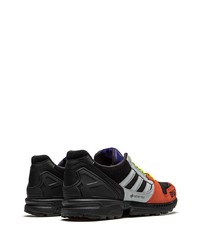 schwarze und orange Sportschuhe von adidas