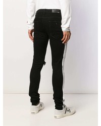 schwarze und weiße enge Jeans mit Destroyed-Effekten von Amiri