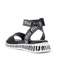 schwarze und weiße flache Sandalen aus Leder von Miu Miu