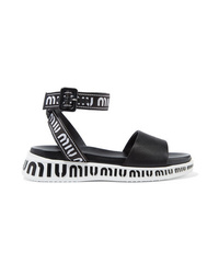 schwarze und weiße flache Sandalen aus Leder von Miu Miu