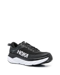 schwarze und weiße Sportschuhe von Hoka One One