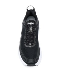 schwarze und weiße Sportschuhe von Hoka One One