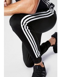 schwarze und weiße vertikal gestreifte Jogginghose von adidas