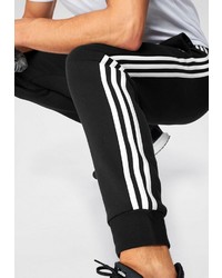 schwarze und weiße vertikal gestreifte Jogginghose von adidas