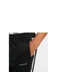 schwarze und weiße vertikal gestreifte Jogginghose von Nike Sportswear