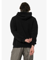 schwarzer bedruckter Pullover mit einem Kapuze von Moschino