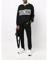 schwarzer und weißer Pullover mit einem Reißverschluss am Kragen von Moschino
