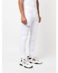 weiße enge Jeans mit Destroyed-Effekten von Amiri