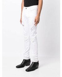 weiße Jeans mit Destroyed-Effekten von Amiri