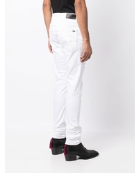 weiße Jeans mit Destroyed-Effekten von Amiri